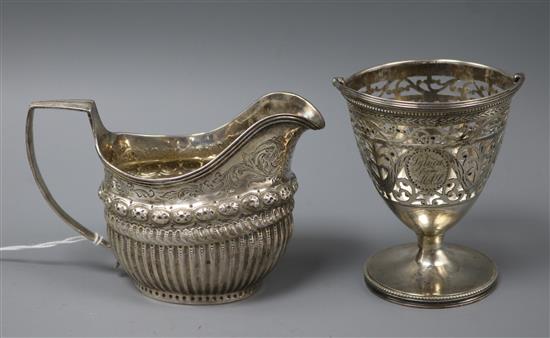 A George III demi fluted silver cream jug and sugar basket and a George III pierced silver sugar basket (no liner). 7.5 oz.
